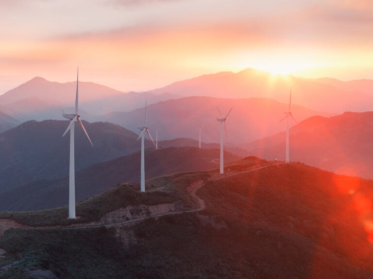 AI in renewable energy - wind farm at sunset.